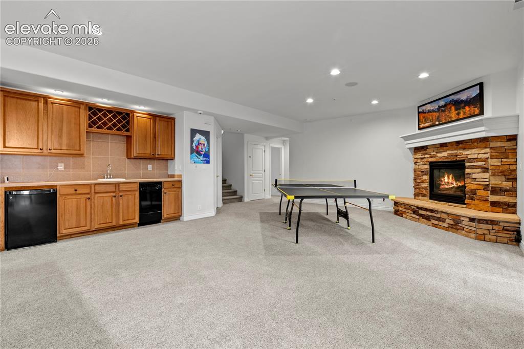 Image 28 of 47: lower level kitchenette with wet bar for seamless entertaining 
