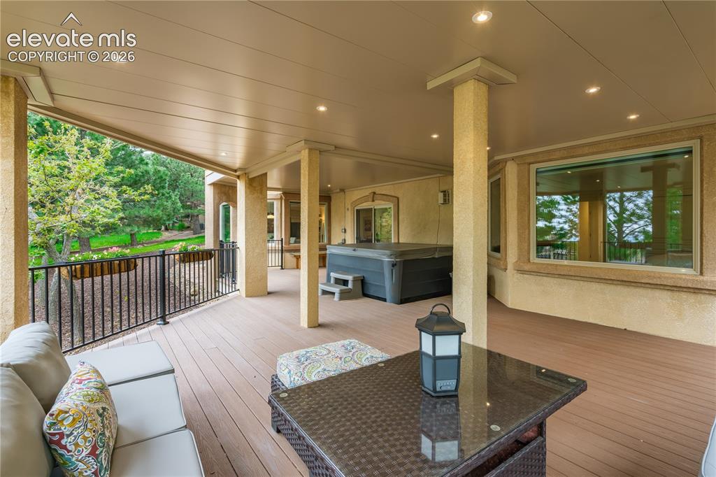 Image 32 of 47: lower level deck with integrated lighting , seating, irrigated planters and