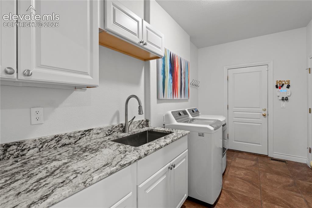 Image 46 of 47: main level upgraded laundry and mudroom with direct access to the garages