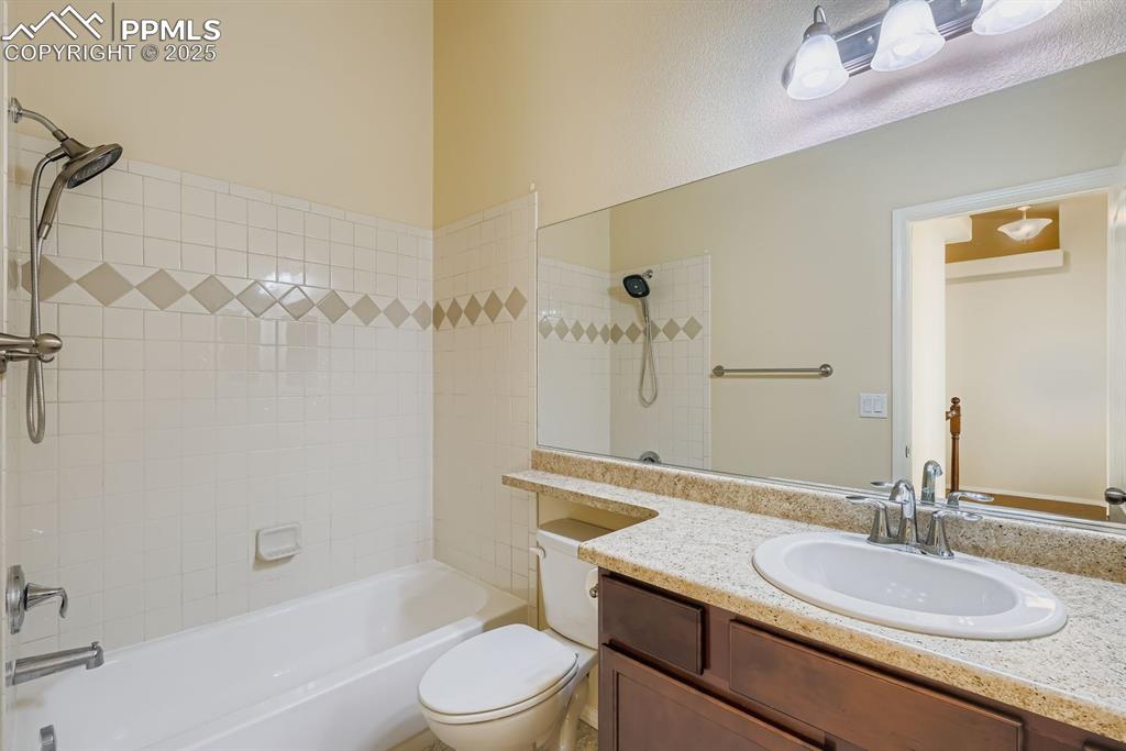 Image 16 of 31: Bathroom with bathing tub / shower combination and vanity