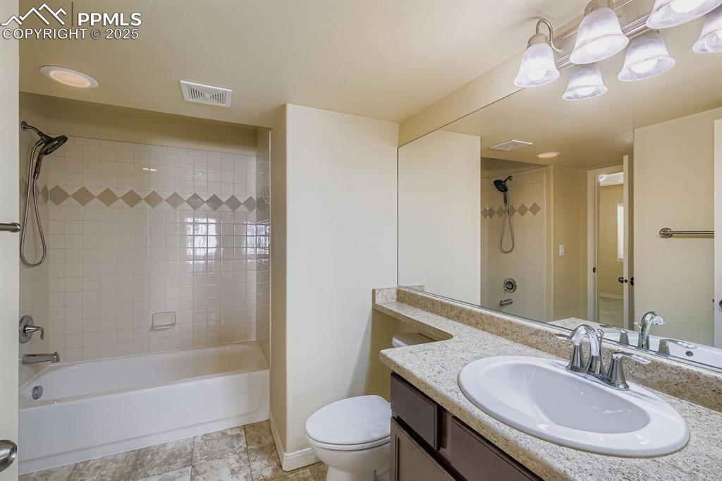 Image 22 of 31: Bathroom with vanity and tub / shower combination