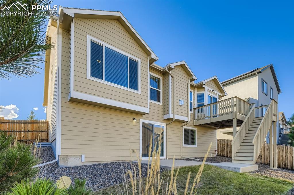 Image 27 of 31: Rear view of house featuring stairway, a patio area, and a wooden deck