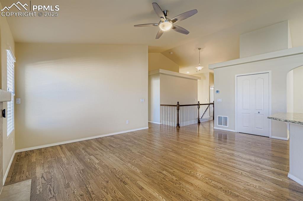 Image 6 of 31: living room with light wood-style floors, vaulted ceiling, and ceiling fan