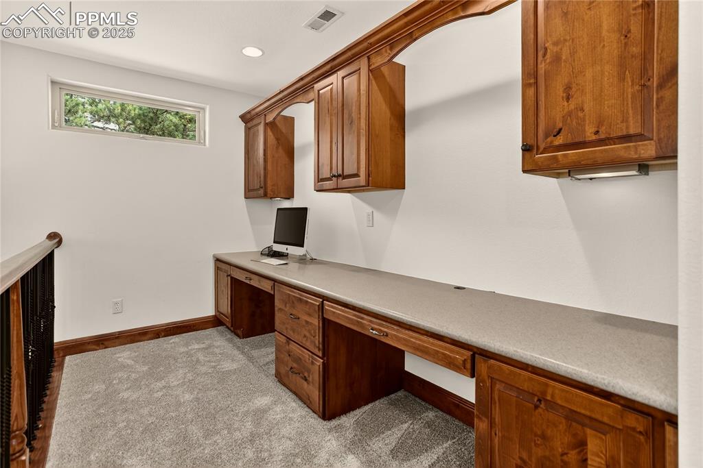 Image 21 of 41: Loft features 4 built-in desks