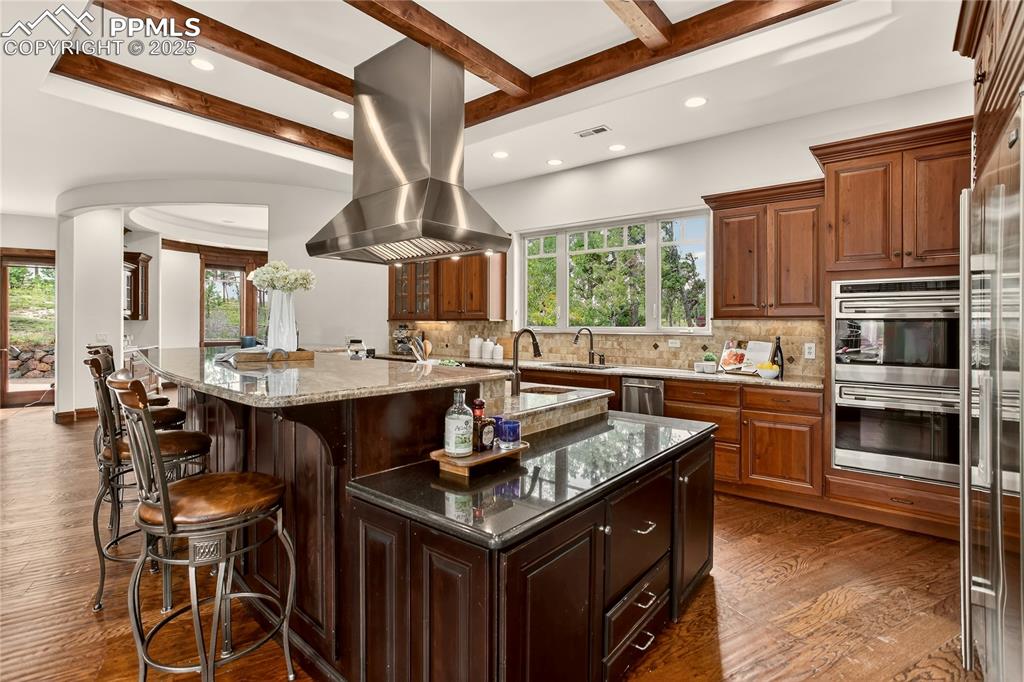 Image 8 of 41: Kitchen with large island & barstool seating