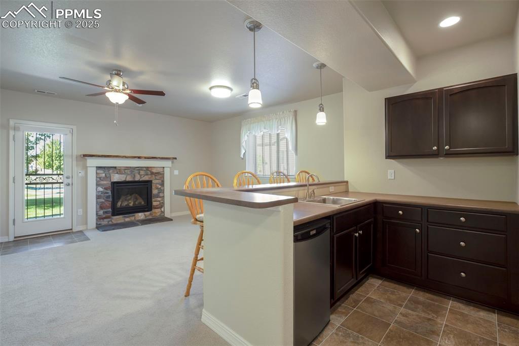 Image 16 of 33: Spacious Wet Bar with Mini Frig and Line of Sight to the Walk-out!