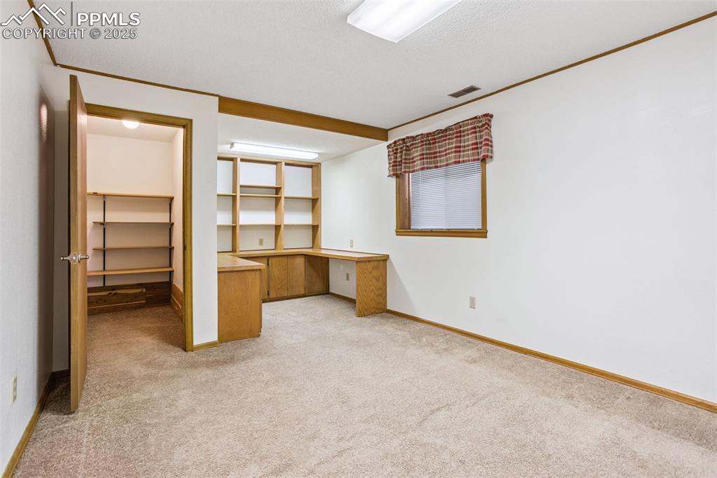 Image 25 of 29: Basement BR/Office with WI closet.