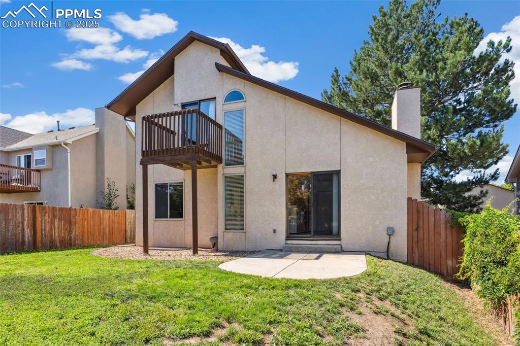 Image 29 of 29: Back view of home with full rear yard fencing.