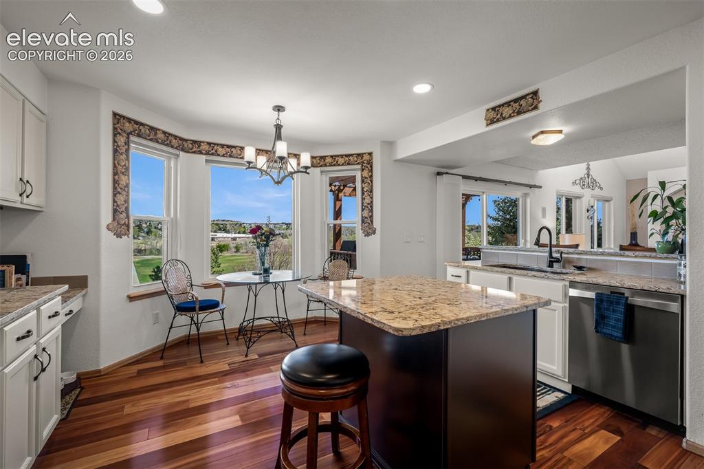 Image 14 of 50: Great picture of kitchen & breakfast area featuring the natural light.