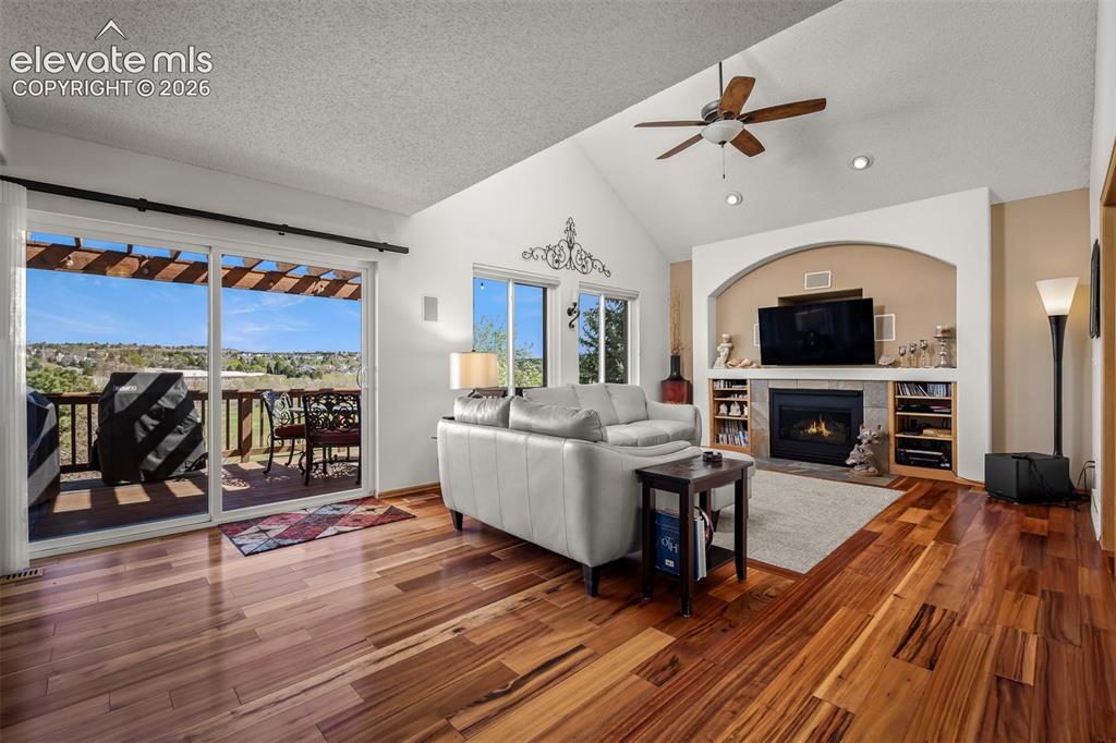 Image 5 of 50: Vaulted ceiling family area with walk out to top deck overlooking the park.