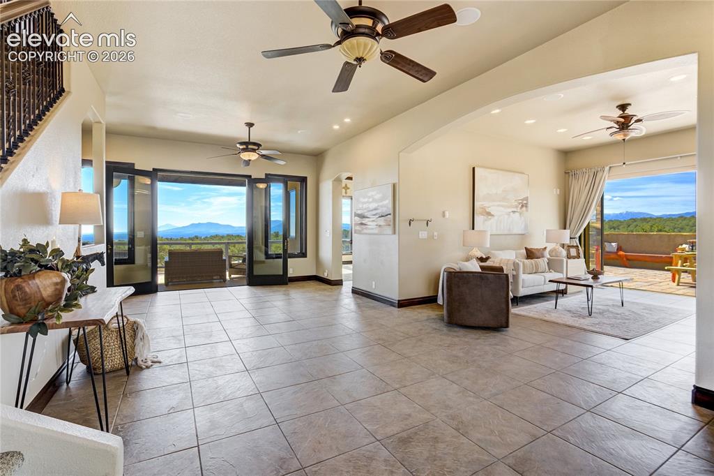 Image 10 of 50: Entry to living room and out to covered deck