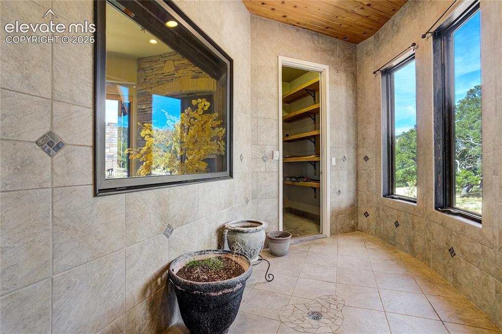 Image 16 of 50: This is a custom garden room with drain/water hookups and adjacent storage 