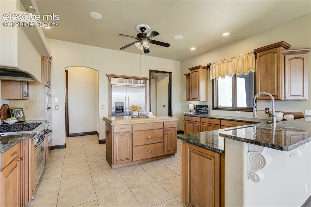 Image 5 of 50: Gourmet kitchen featuring stainless steel appliances, a center island with