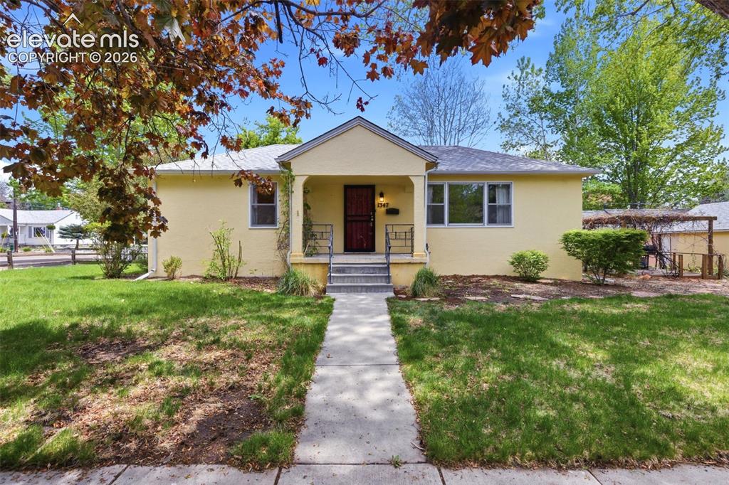 Image 1 of 46: Single-story residence featuring a yellow stucco exterior, covered front po