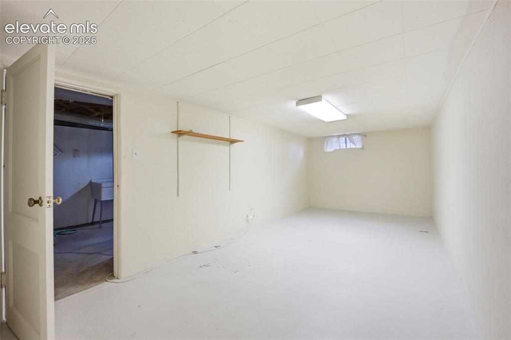 Image 23 of 46: White-painted interior space featuring a drop ceiling with recessed lightin