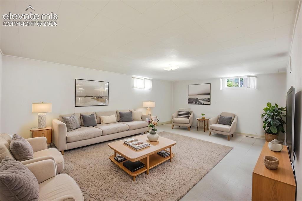 Image 31 of 46: Spacious living area featuring white walls, light-colored flooring, and rec