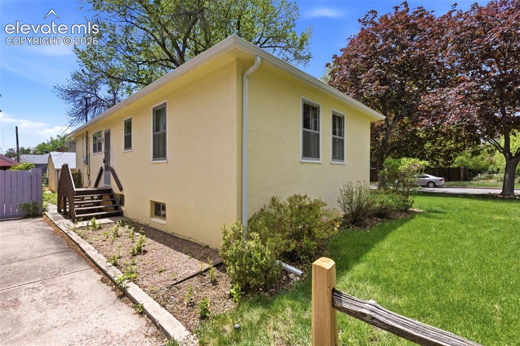 Image 36 of 46: Light yellow exterior with white trim and multiple windows
