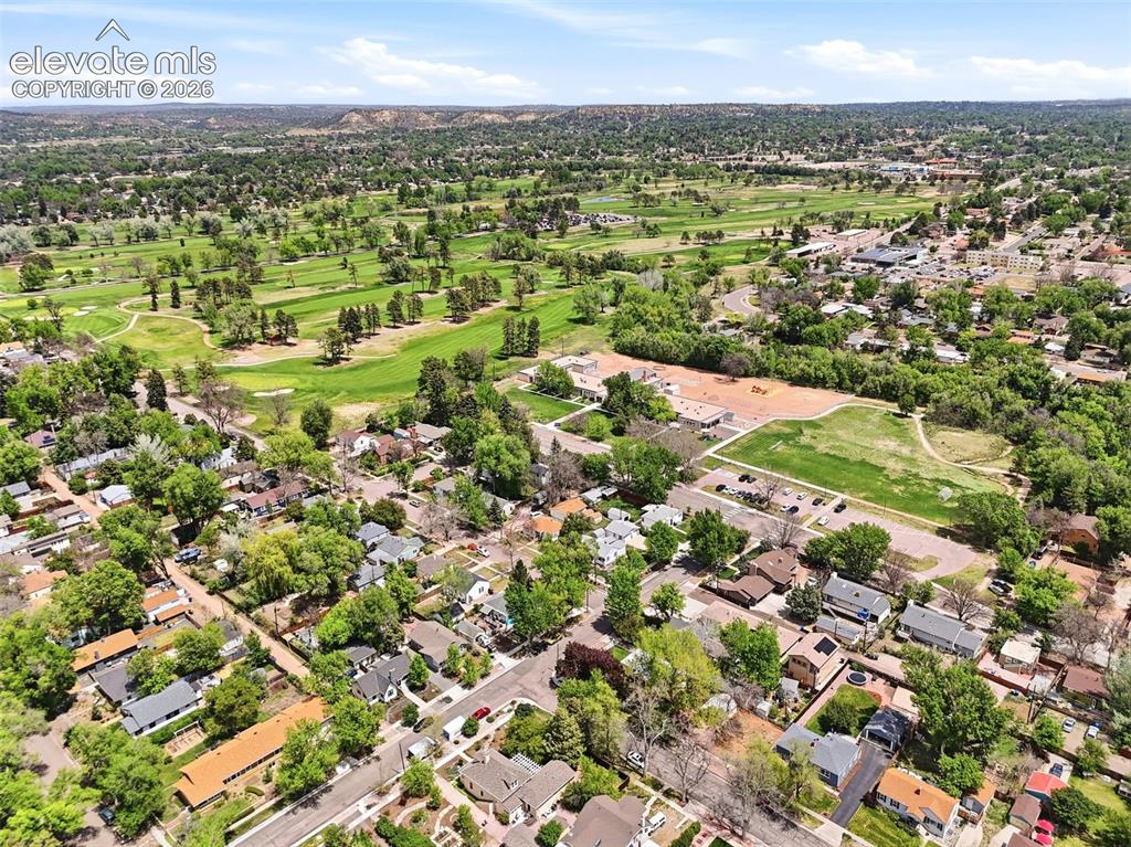 Image 43 of 46: Aerial perspective showcasing an expansive, tree-lined neighborhood