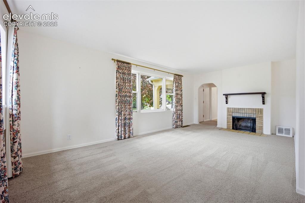 Image 6 of 46: Spacious room featuring light-toned carpeting and white walls