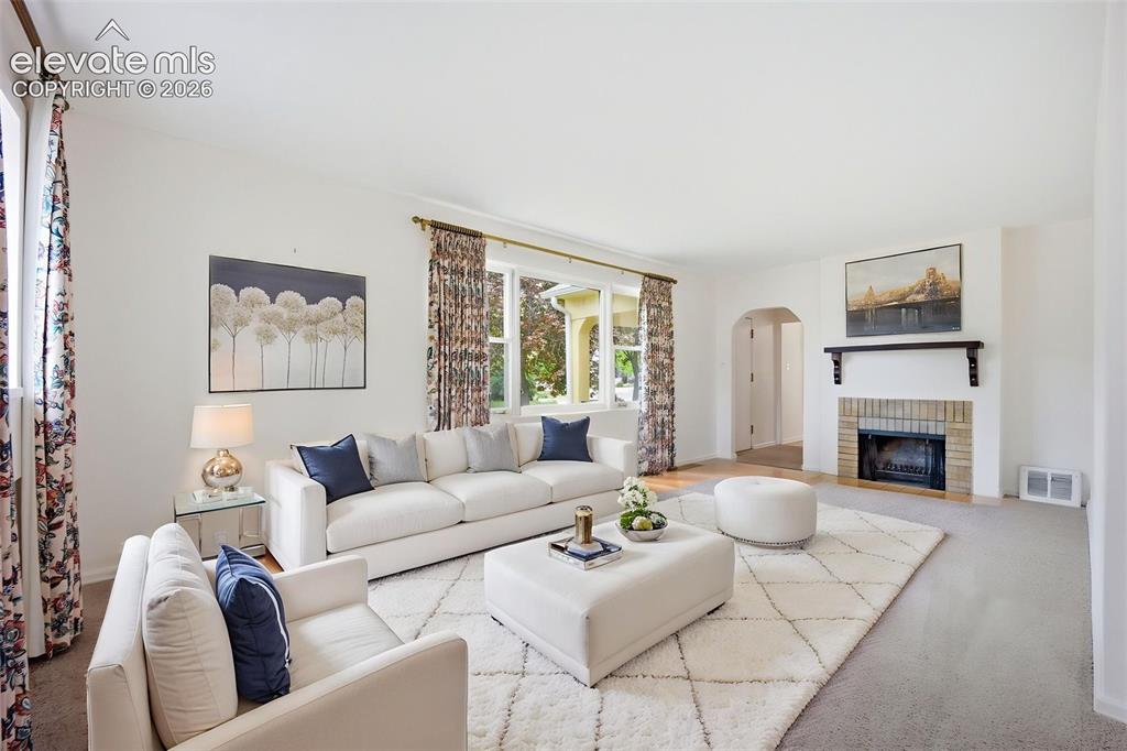 Image 7 of 46: Living room featuring light-toned walls and wood-finish flooring