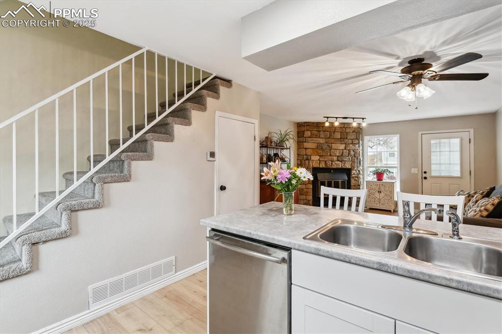 Image 14 of 24: Kitchen with a sink, visible vents, open floor plan, and dishwasher