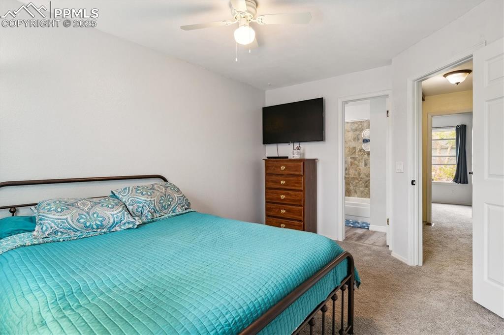 Image 17 of 24: Bedroom with baseboards, a ceiling fan, and carpet flooring