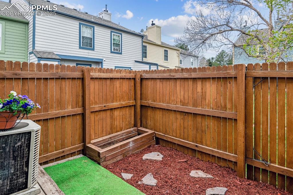 Image 20 of 24: View of yard featuring fence and central AC unit