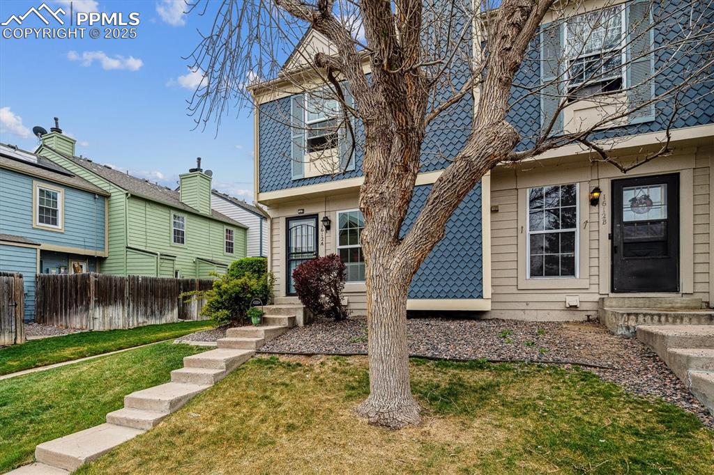 Image 3 of 24: View of front of property with fence, a front yard, and entry steps