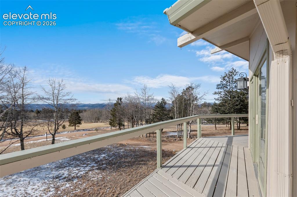 Image 11 of 40: Expansive outdoor deck with wood-finish decking and railing, offering open 