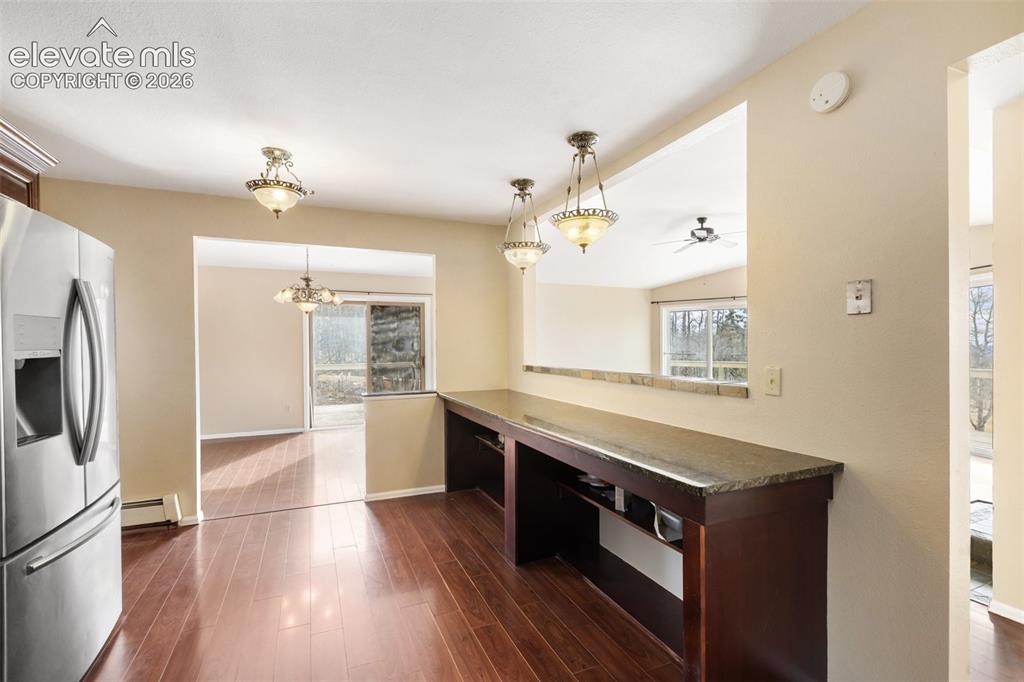Image 19 of 40: Hardwood-finish flooring, stainless steel refrigerator, built-in counter wi