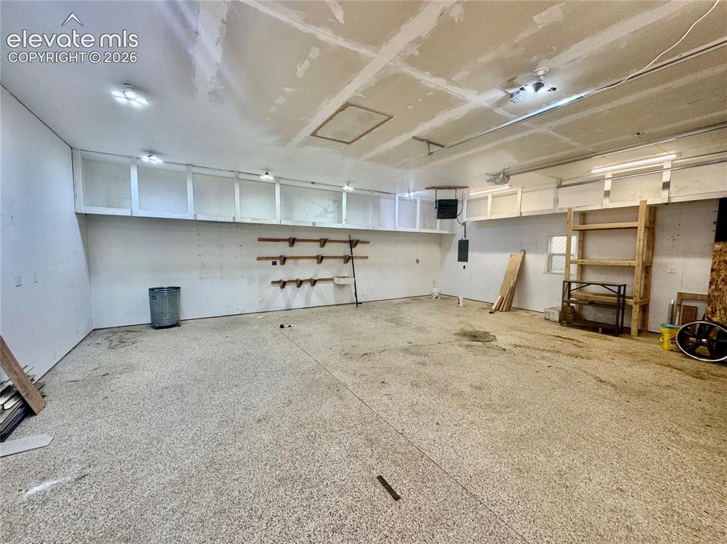 Image 8 of 40: Detached Garage/Shop interior space with overhead storage cabinetry, wall-m