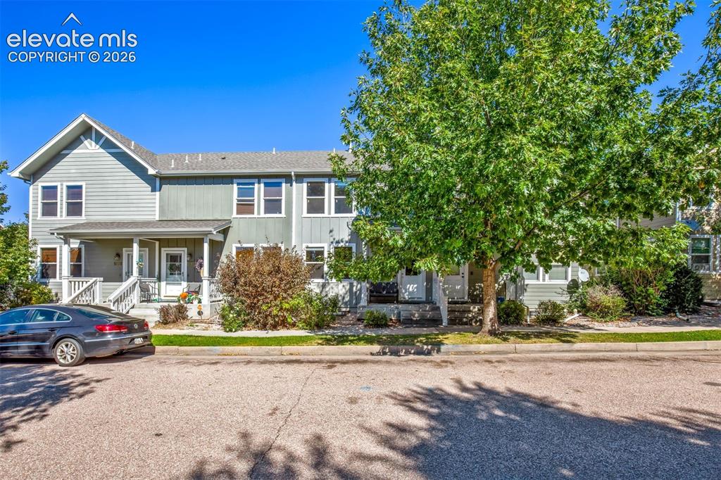 Caption: Home has a beautiful shade tree in front of front porch