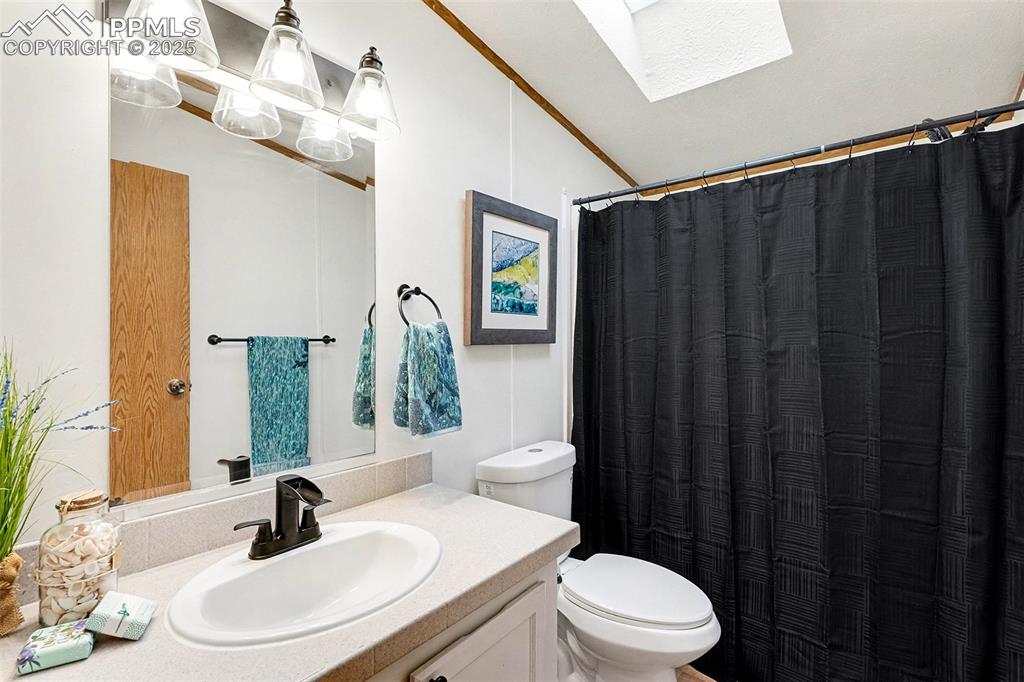 Image 11 of 15: Main bathroom with new plumbing fixtures, new toilet, refurbished counters,