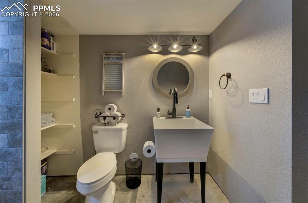 Image 26 of 29: Bathroom with a textured wall