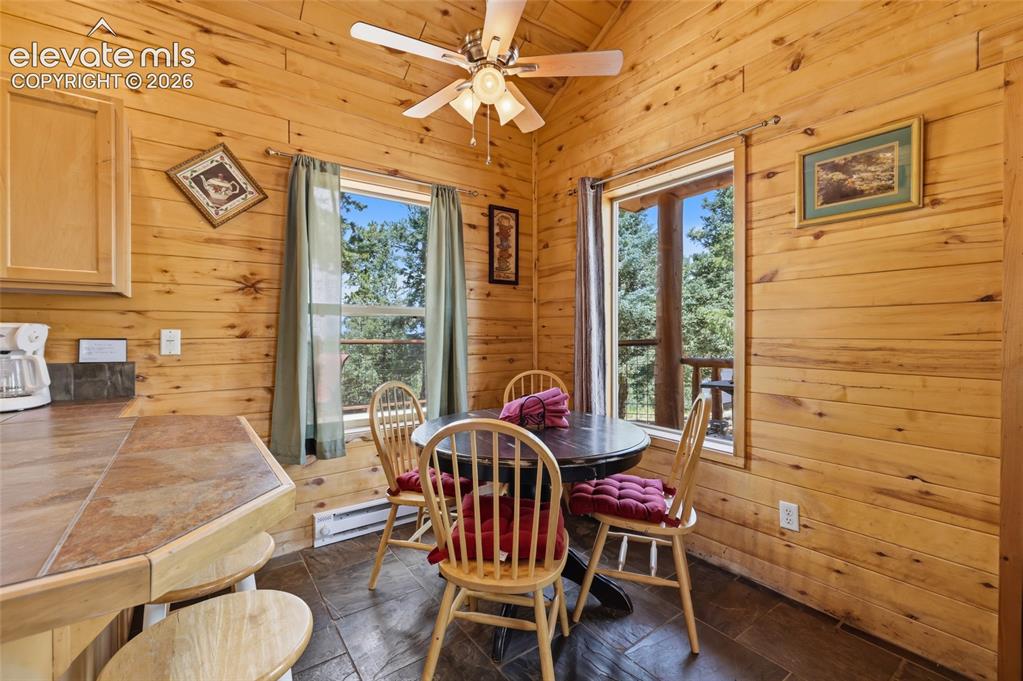 Image 17 of 28: Vaulted wood-paneled ceilings over a spacious room with wood-finish walls