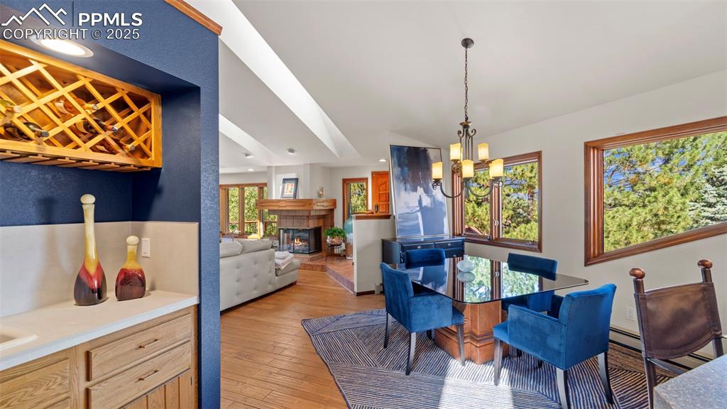 Image 15 of 46: The dining area framed by architecturally designed windows and enhanced wit
