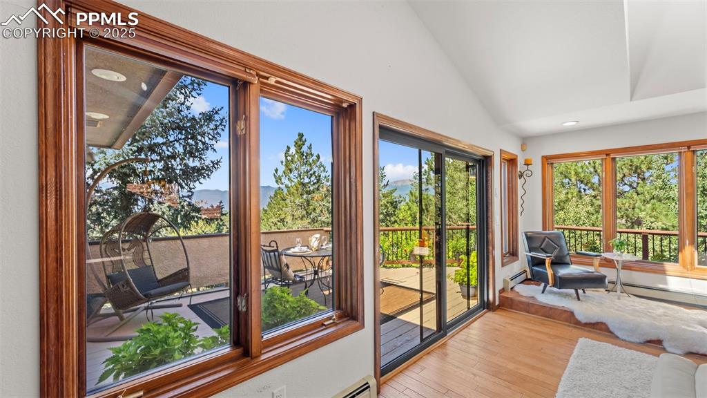 Image 22 of 46: Sunroom with hardwood / wood-style flooring, vaulted ceiling, recessed ligh