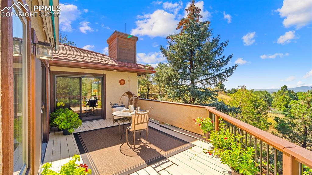 Image 24 of 46: Wooden deck with outdoor dining area