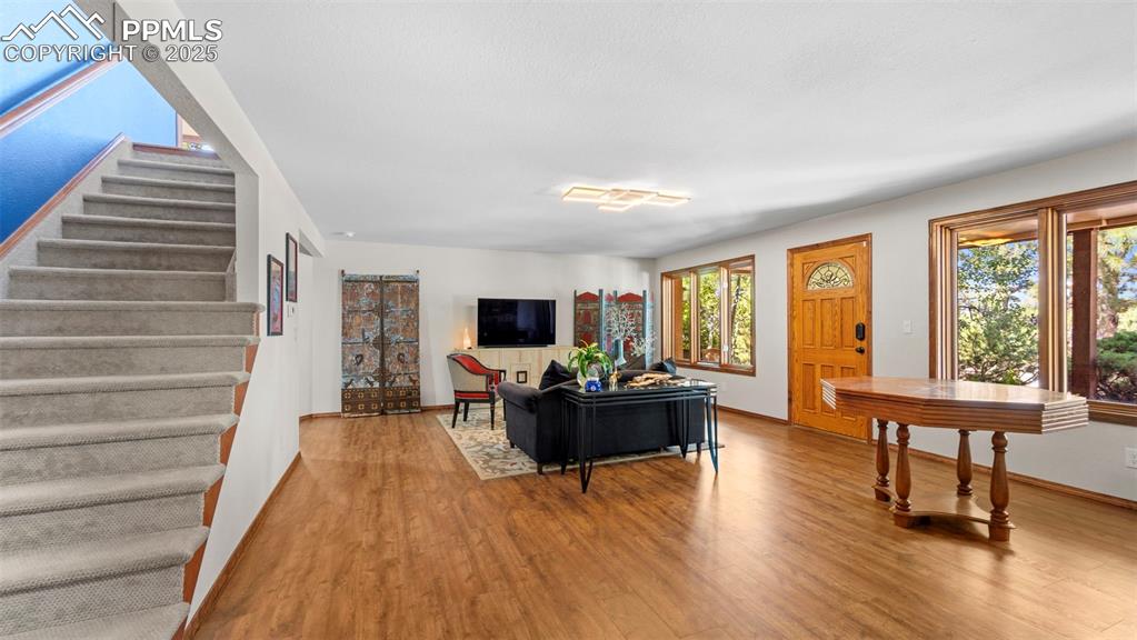 Image 30 of 46: This expansive living room, adorned with stunning flooring, flows seamlessl