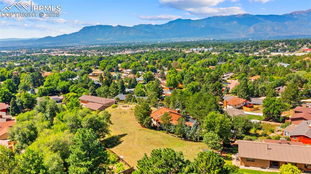 Image 38 of 46: Aerial perspective of suburban area featuring a mountain backdrop