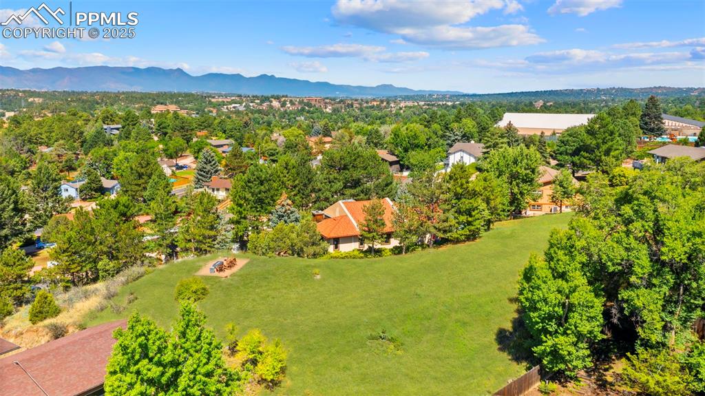 Image 39 of 46: Aerial view of residential area with a mountain backdrop