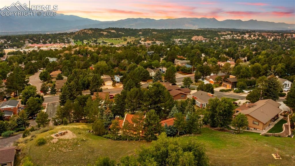 Image 45 of 46: Aerial view of residential area with a mountainous background