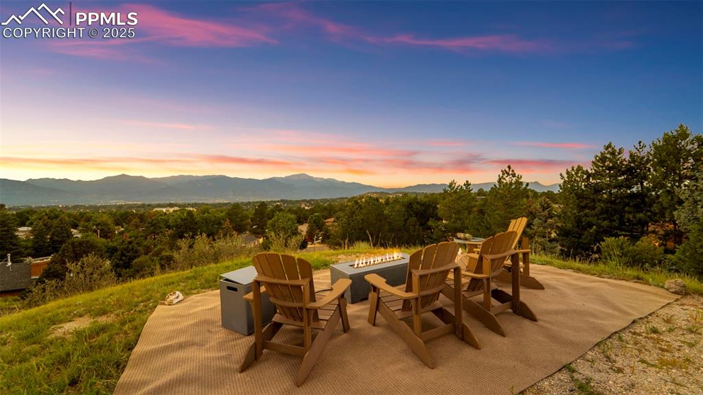 Image 46 of 46: View of patio featuring a mountain view and a fire pit