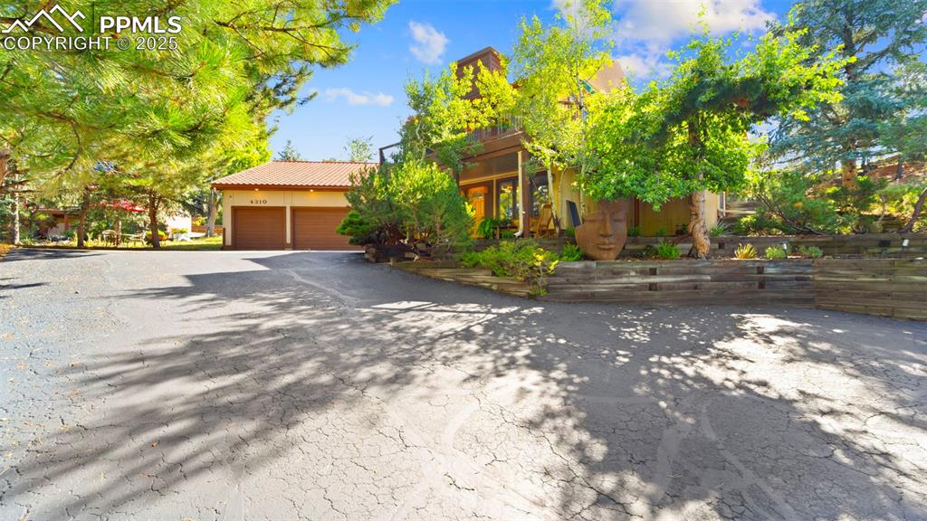 Image 6 of 46: Designed for privacy and tranquility, this private driveway leads you to yo