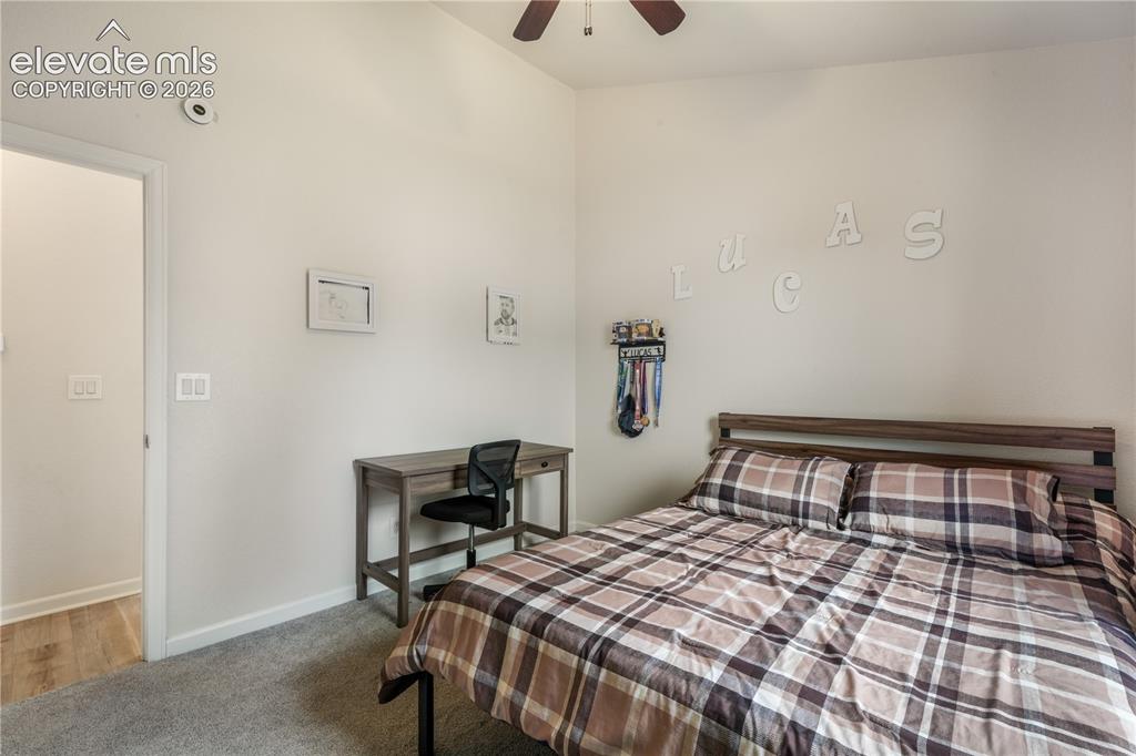 Image 22 of 50: Upper Level Bedroom with Ceiling Fan
