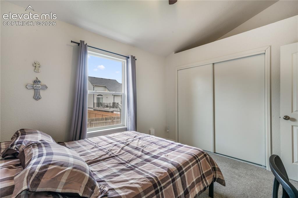 Image 23 of 50: Upper Level Bedroom with Vaulted Ceilings