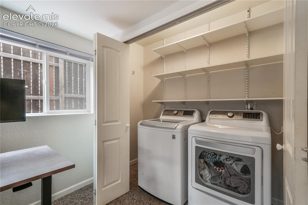 Image 32 of 50: Lower Level Laundry with Upper Shelving