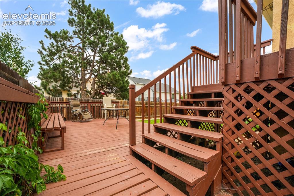 Image 40 of 50: Stairs from Back Deck to Lower Back Patio