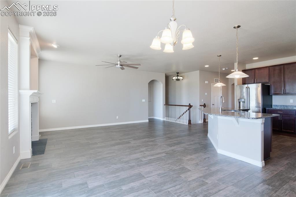 Image 10 of 36: Spacious open concept living area featuring tile flooring, a fireplace, and