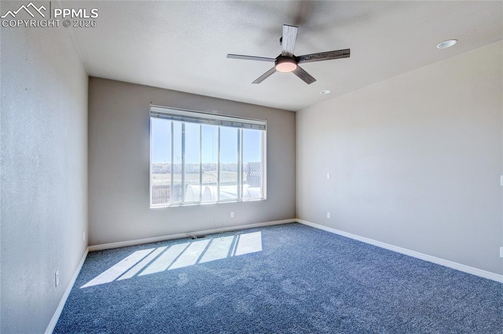 Image 15 of 36: Spacious room featuring carpeting, a ceiling fan with integrated lighting, 